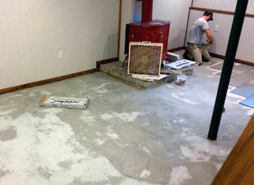 Kyle Swanson Tiling Floor Kyle Swanson tiling a basement floor